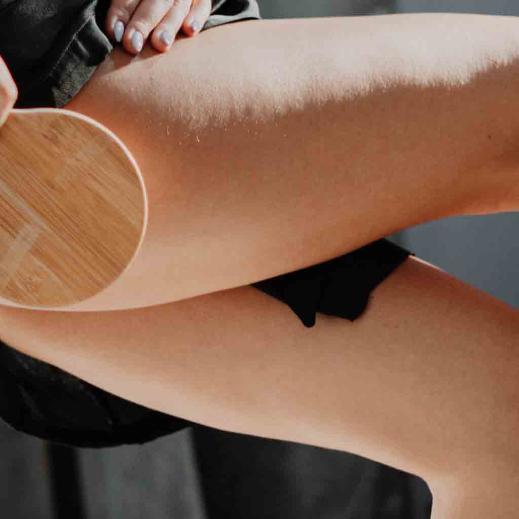 Cellulite apperance on the thighs of young lady and how skincare products can improve cellulite